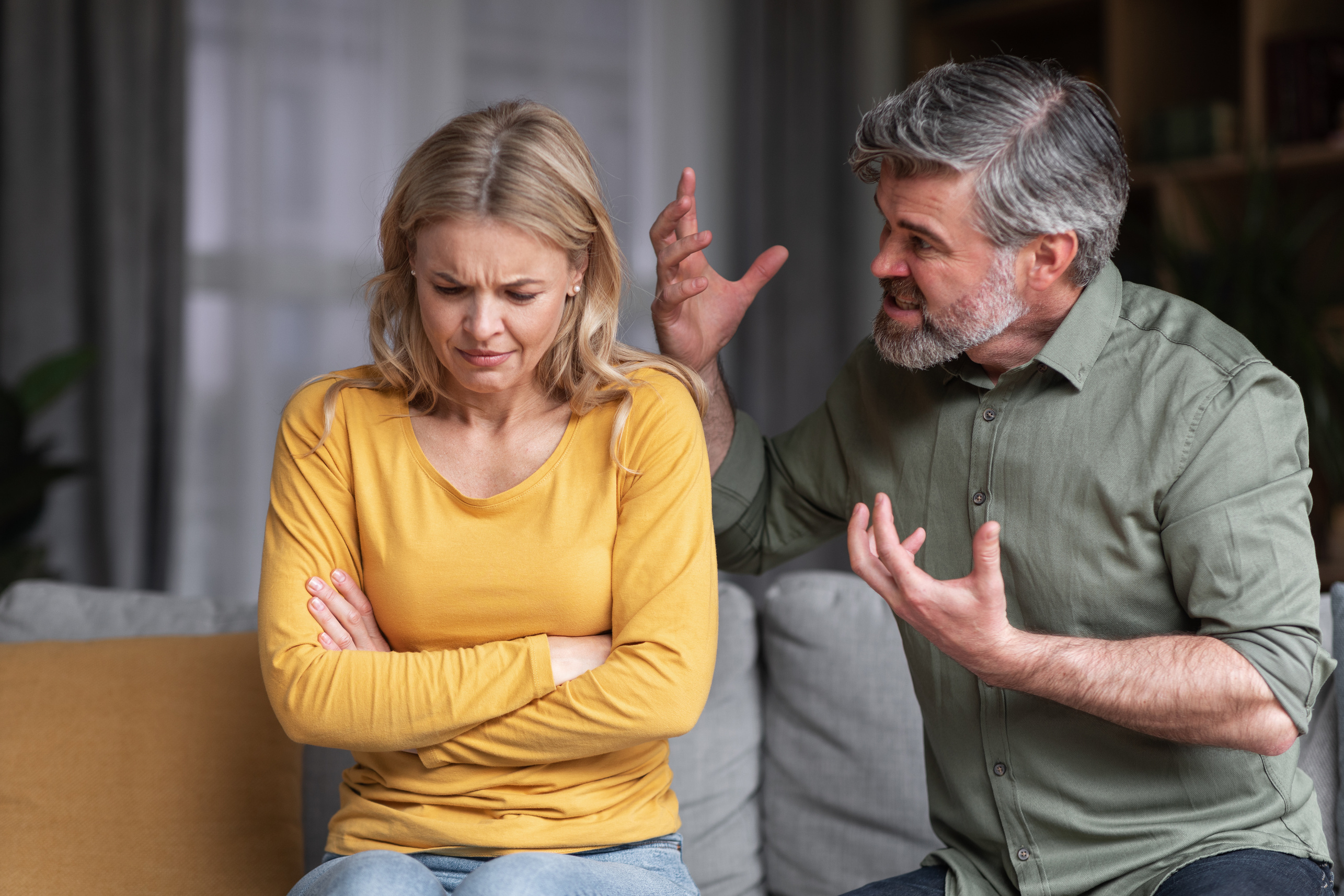 Aggressive Behavior. Portrait Of Abusive Husband Shouting At Wife At Home