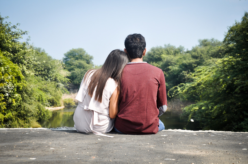 Happy Couple Sitting at  Lake
